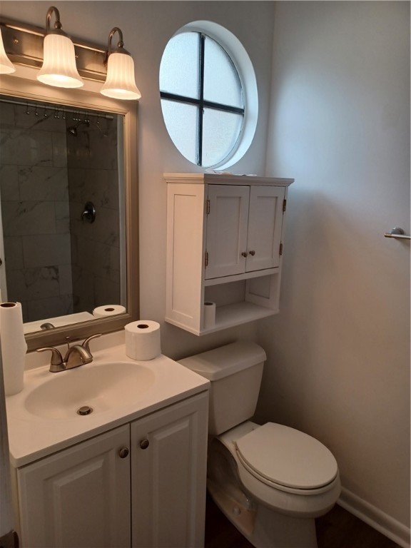 Undisclosed Address Vero Beach, FL 32960 - Photo 17 of 18 a bathroom with a toilet a sink and mirror