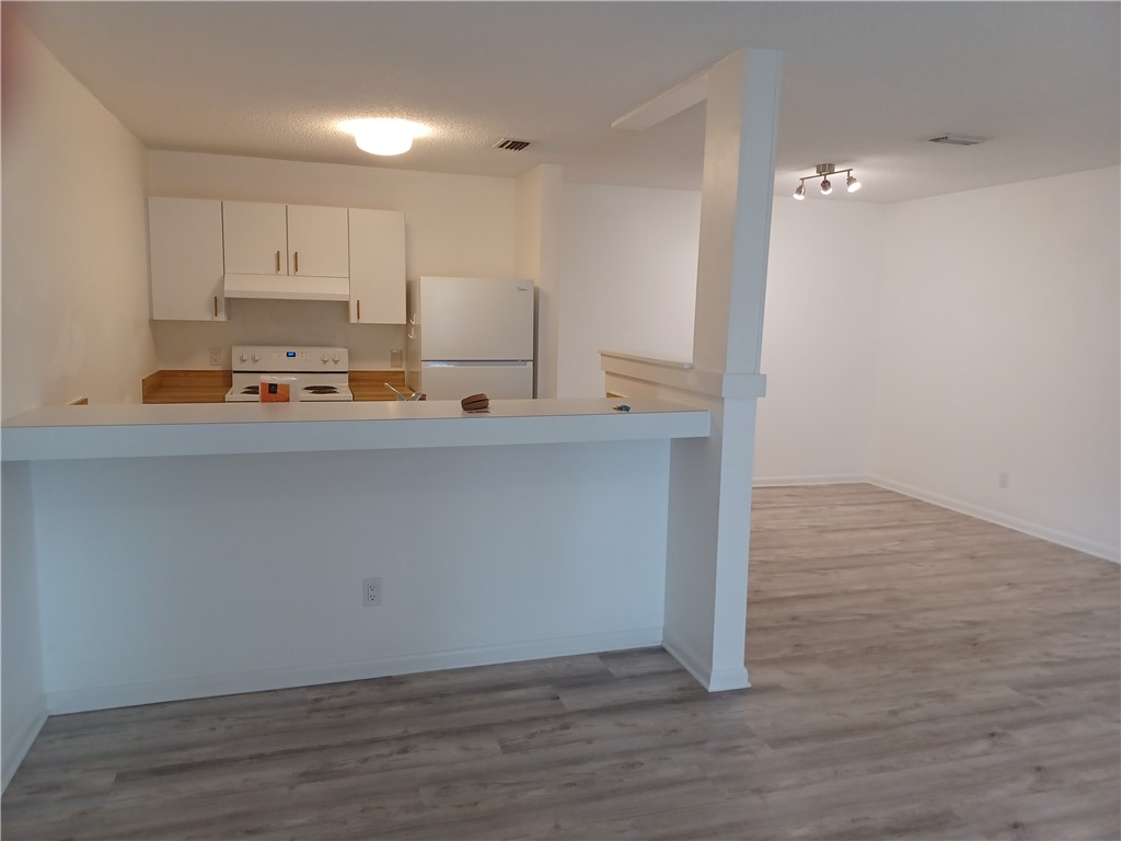 Undisclosed Address Vero Beach, FL 32960 - Photo 6 of 18 a view of kitchen with wooden floor