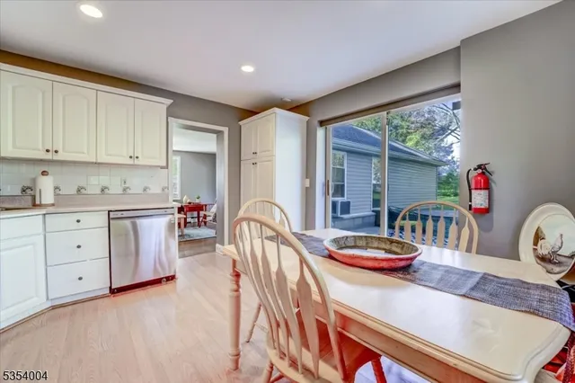 a dining room with furniture a window and kitchen view