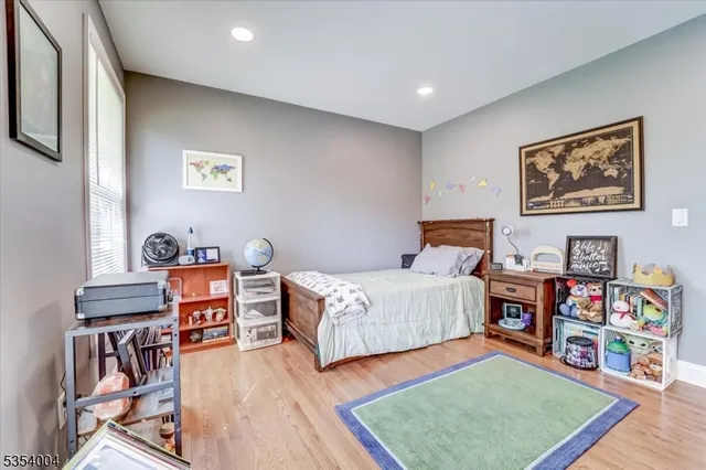 a bedroom with furniture and a book shelf