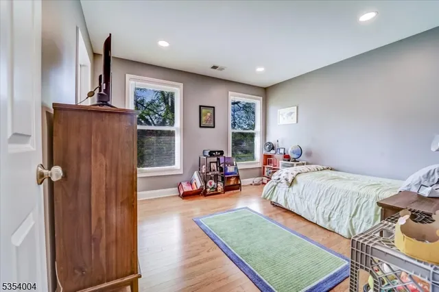 a bed room with furniture and a wooden floor
