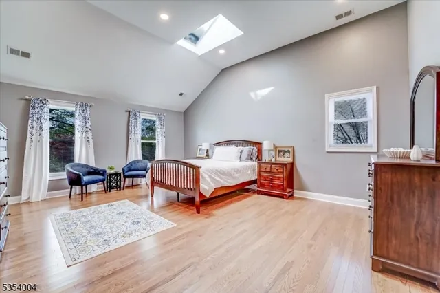 a bedroom with a bed a couch and dresser