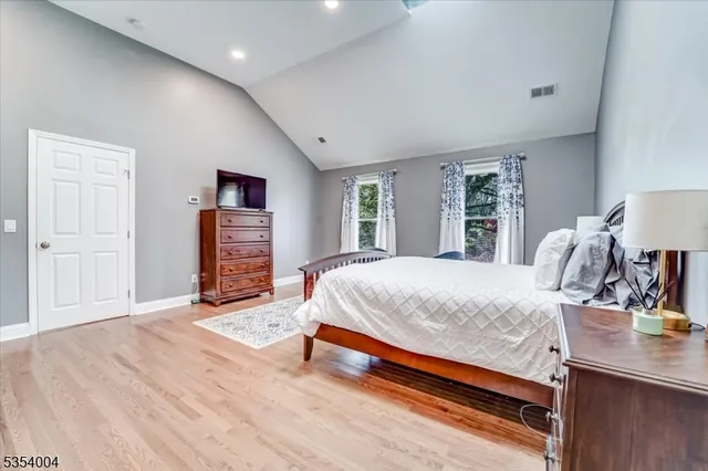 a bed room with a bed and dresser