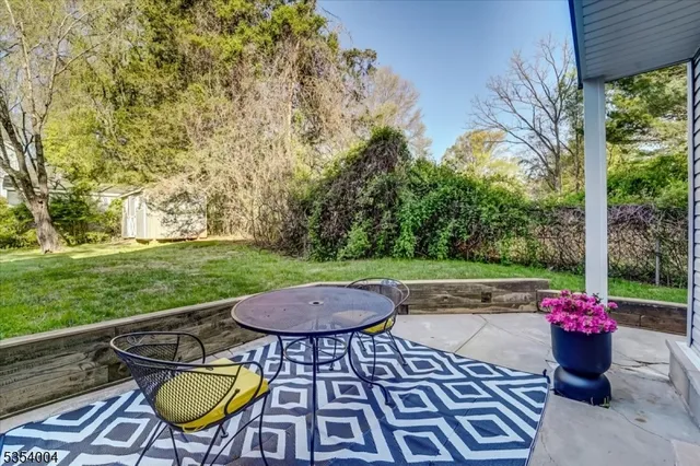 a view of a chairs and table in backyard