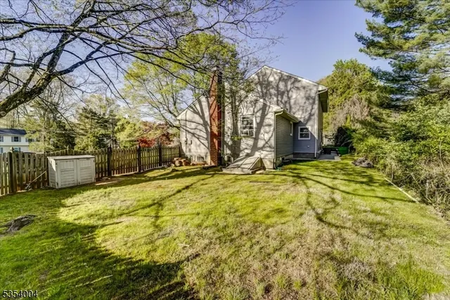 a view of a yard with large trees