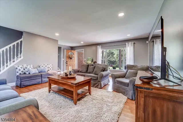 a living room with furniture a rug and a window