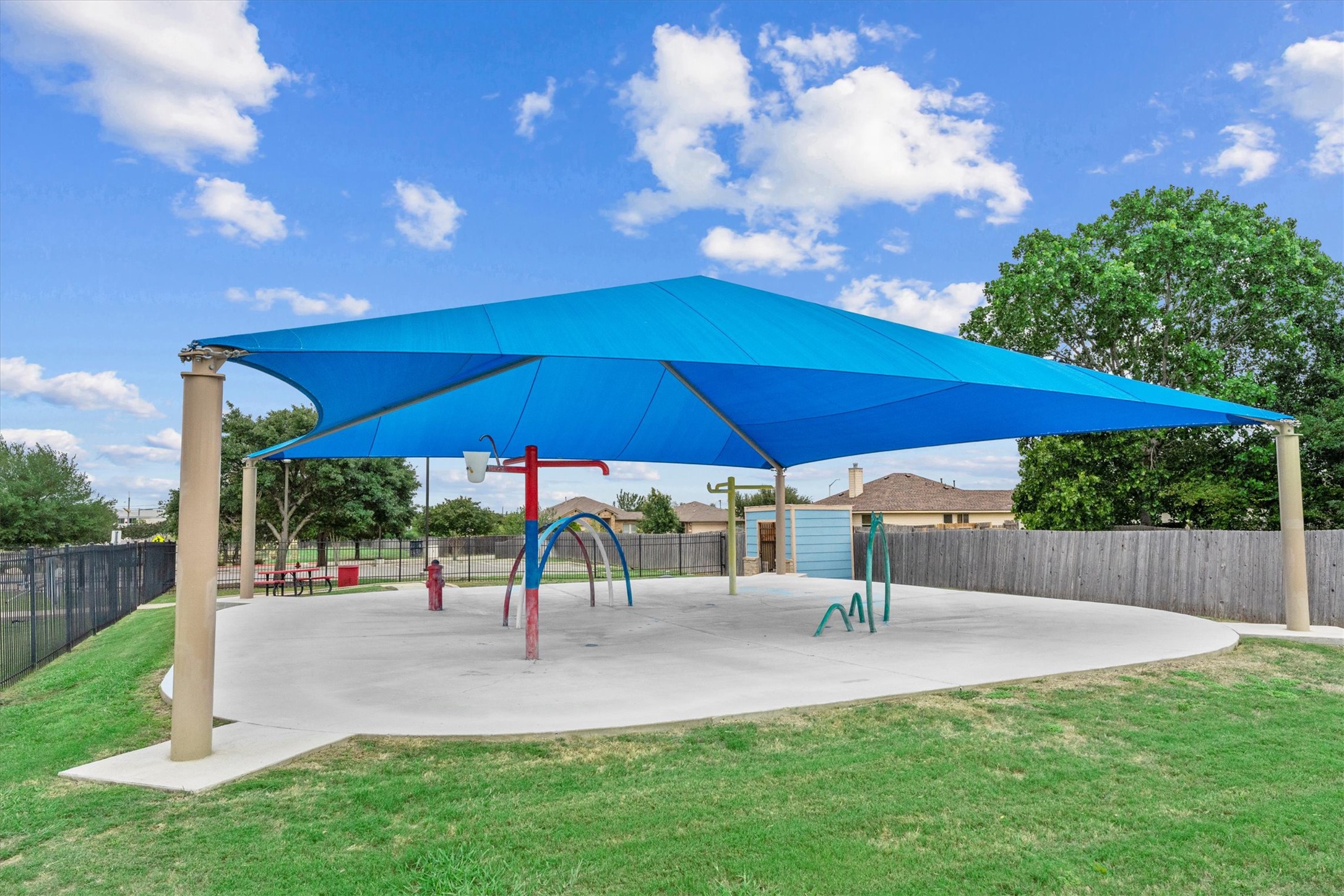 172 Discovery Kyle, TX 78640 - Photo 19 of 21 Community splash pad with covered seating, offering a fun space to cool off during the summer.
