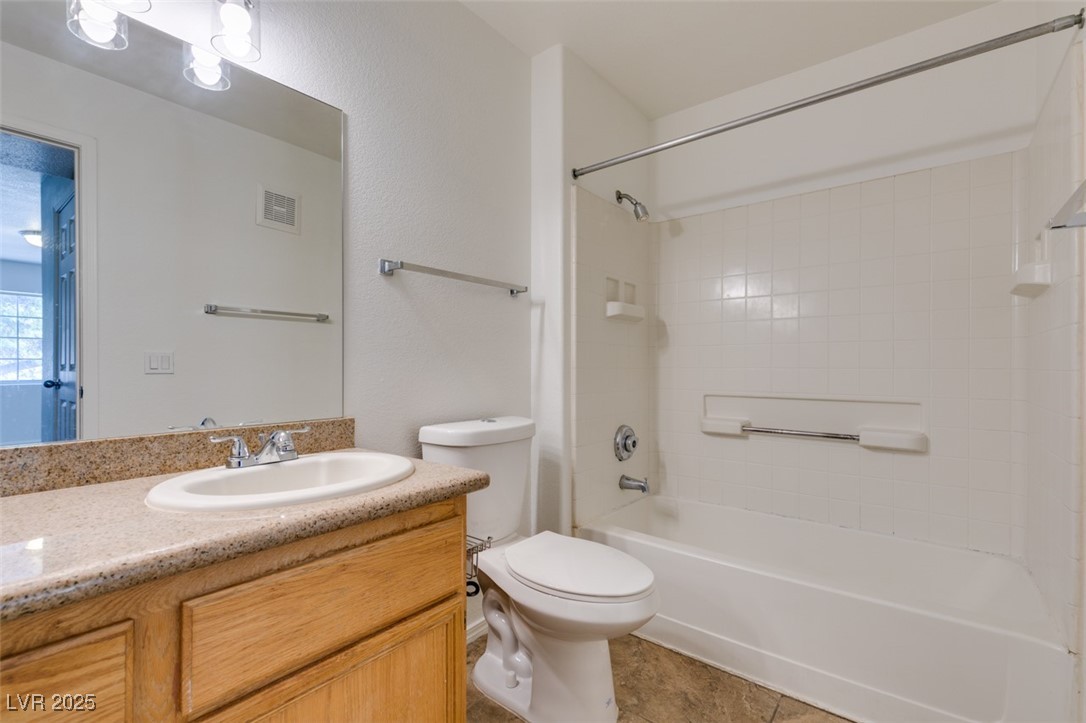 3318 North Decatur Boulevard, Unit 2138 Las Vegas, NV 89130 - Photo 34 of 40 Full bath with vanity, shower / bath combination, toilet, and tile patterned flooring