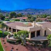 a aerial view of a house with garden space and a patio