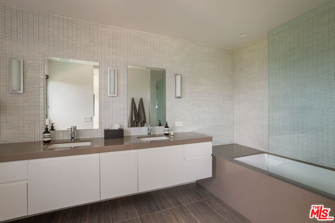 3337 Beverly Ranch Road Beverly Hills, CA 90210 - Photo 27 of 36 a bathroom with a double vanity sink and mirror