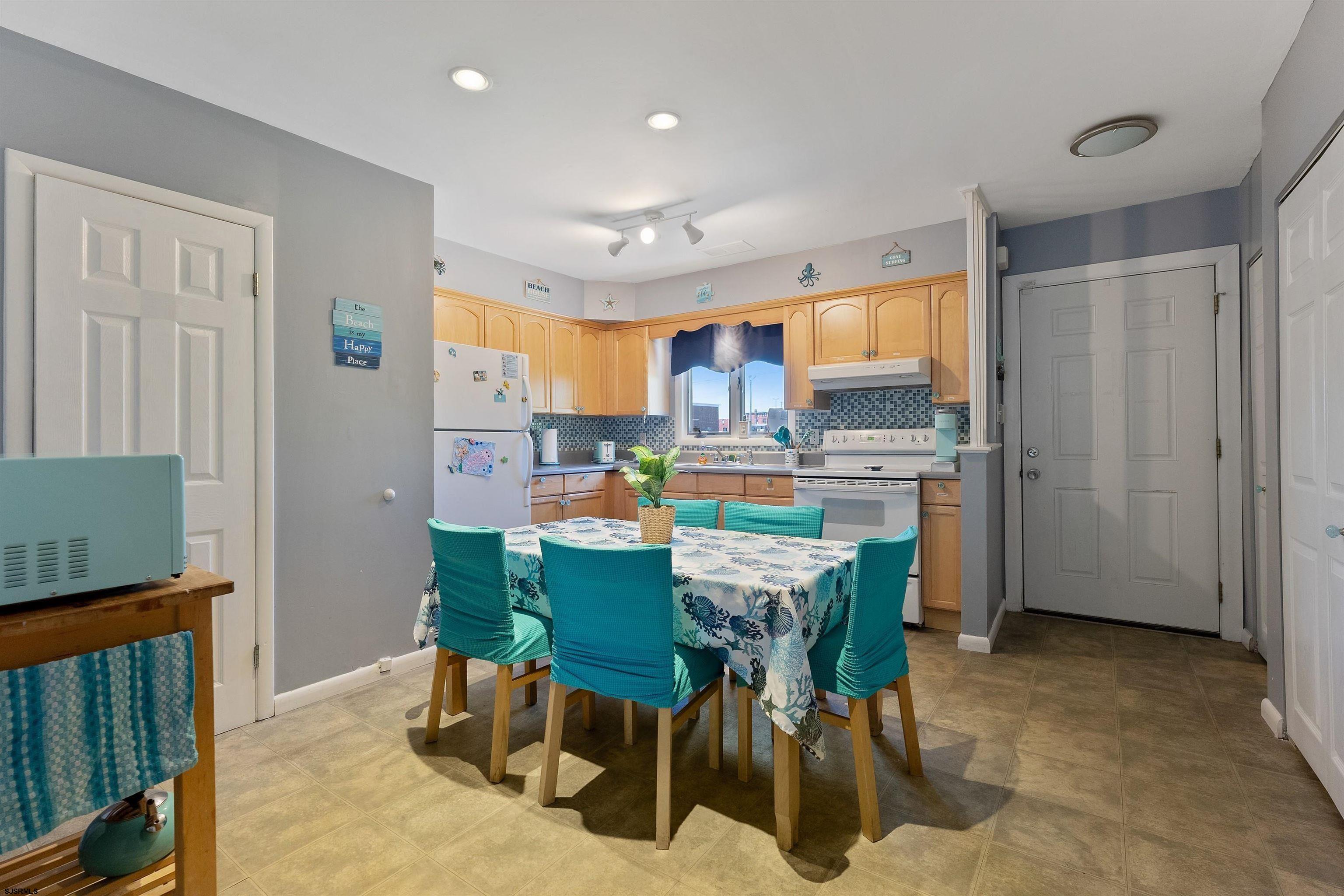 101 East Oak Avenue Wildwood, NJ 08260 - Photo 3 of 8 a dining room with stainless steel appliances a table and chairs