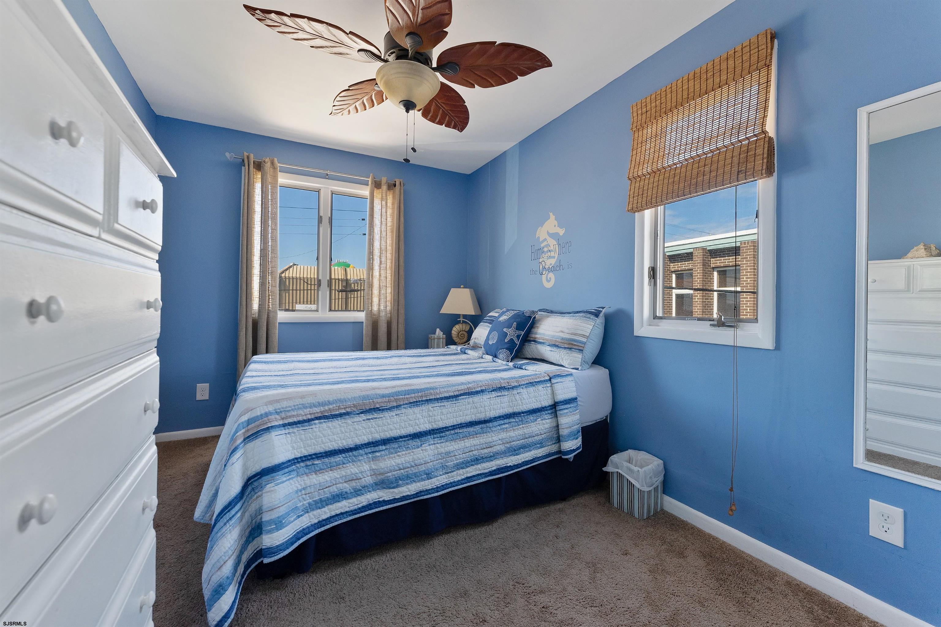 101 East Oak Avenue Wildwood, NJ 08260 - Photo 8 of 8 a bedroom with a bed and a chandelier