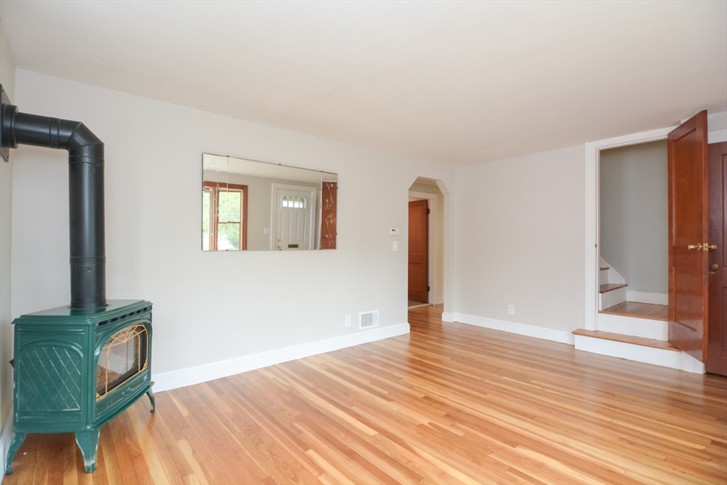 95 Sunset Avenue Dedham, MA 02026 - Photo 12 of 39 a view of an empty room with wooden floor and a window