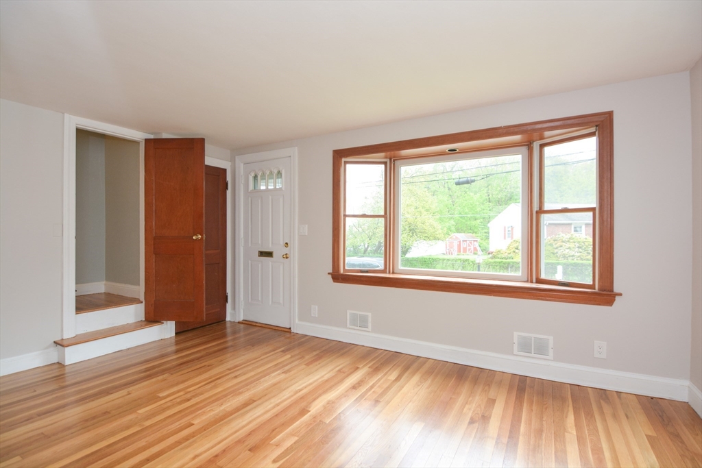 95 Sunset Avenue Dedham, MA 02026 - Photo 13 of 39 a view of an empty room with wooden floor and a window
