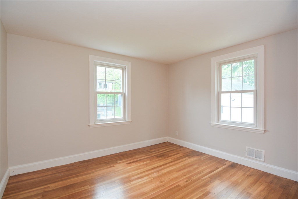 95 Sunset Avenue Dedham, MA 02026 - Photo 14 of 39 an empty room with wooden floor and windows
