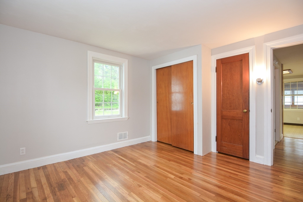 95 Sunset Avenue Dedham, MA 02026 - Photo 15 of 39 an empty room with wooden floor and windows