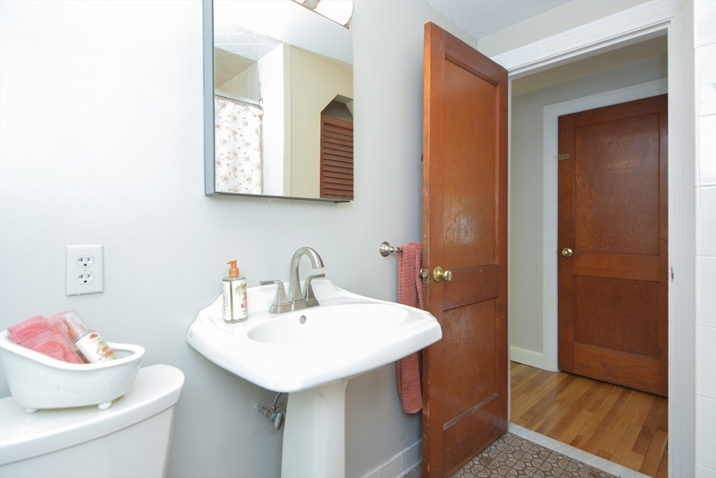 95 Sunset Avenue Dedham, MA 02026 - Photo 18 of 39 a bathroom with a sink and a mirror