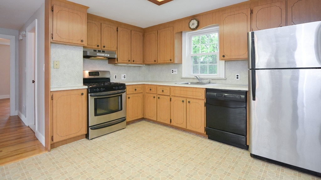 95 Sunset Avenue Dedham, MA 02026 - Photo 19 of 39 a kitchen with stainless steel appliances granite countertop a refrigerator sink and stove
