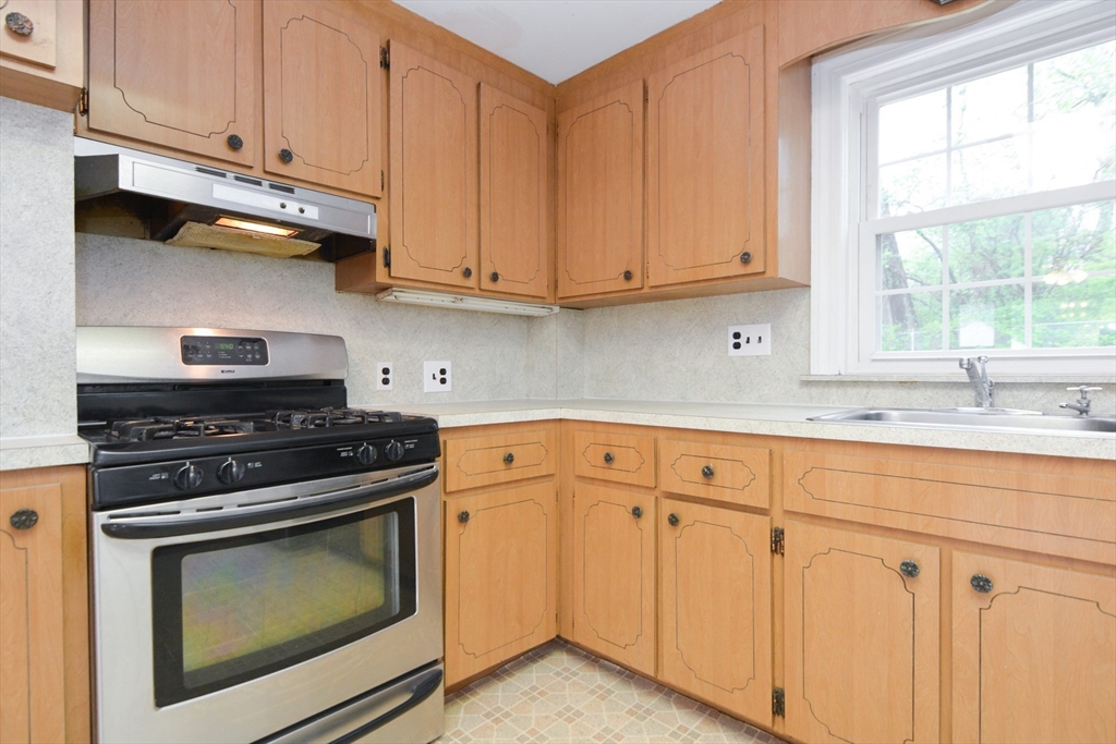 95 Sunset Avenue Dedham, MA 02026 - Photo 20 of 39 a kitchen with granite countertop white cabinets and appliances