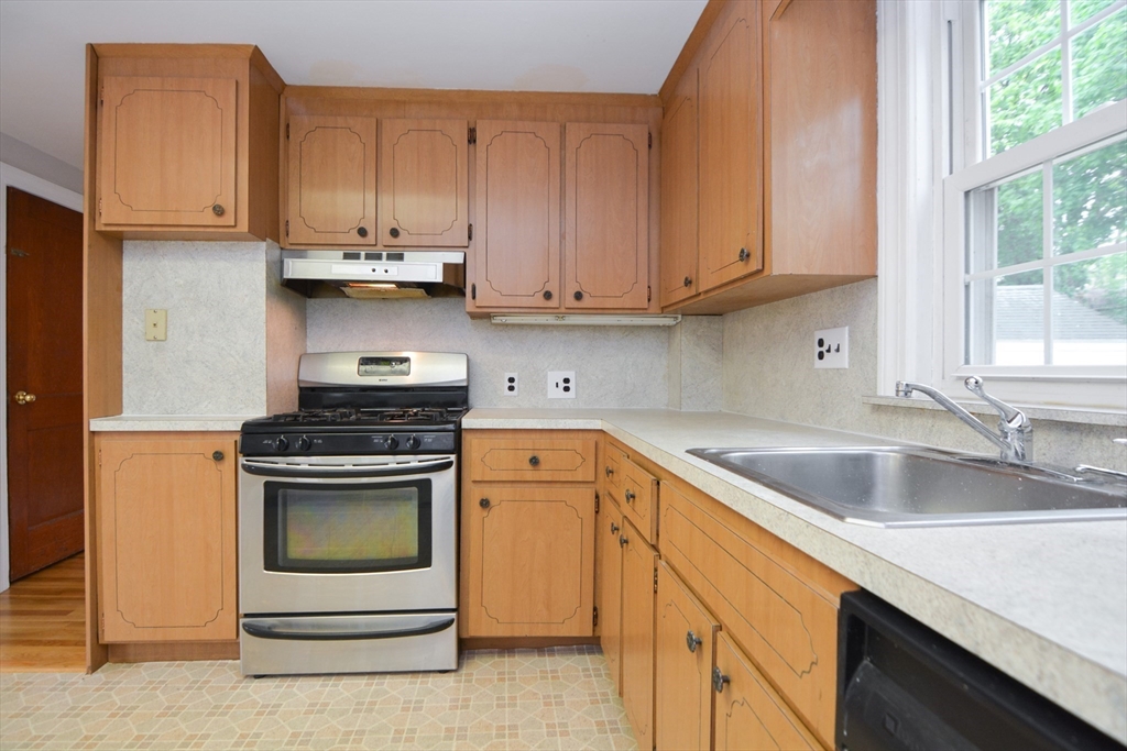 95 Sunset Avenue Dedham, MA 02026 - Photo 21 of 39 a kitchen with stainless steel appliances granite countertop a sink stove and refrigerator