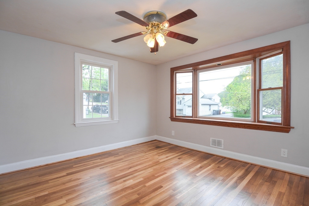 95 Sunset Avenue Dedham, MA 02026 - Photo 24 of 39 a view of an empty room with wooden floor and a window