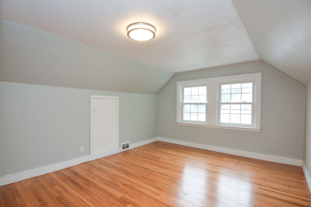 95 Sunset Avenue Dedham, MA 02026 - Photo 3 of 39 an empty room with wooden floor and windows