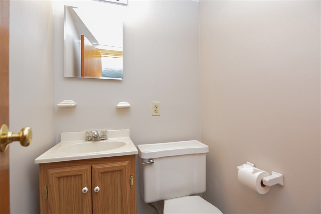 95 Sunset Avenue Dedham, MA 02026 - Photo 32 of 39 a bathroom with a sink mirror and toilet