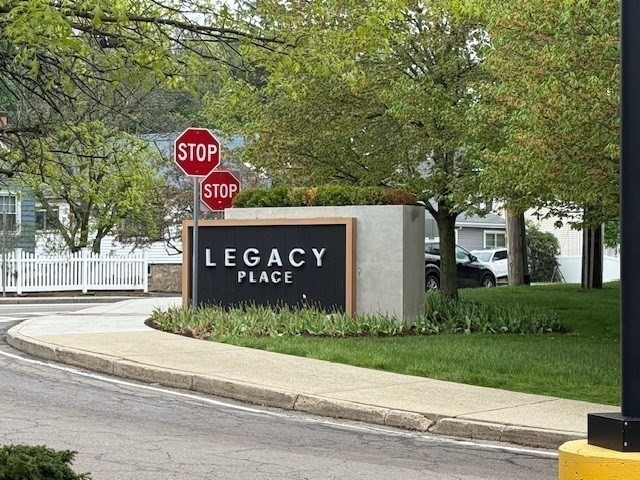 95 Sunset Avenue Dedham, MA 02026 - Photo 38 of 39 a view of a street sign under a large tree