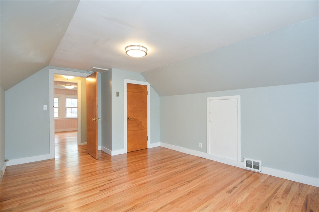 95 Sunset Avenue Dedham, MA 02026 - Photo 5 of 39 a view of an empty room with wooden floor and a window