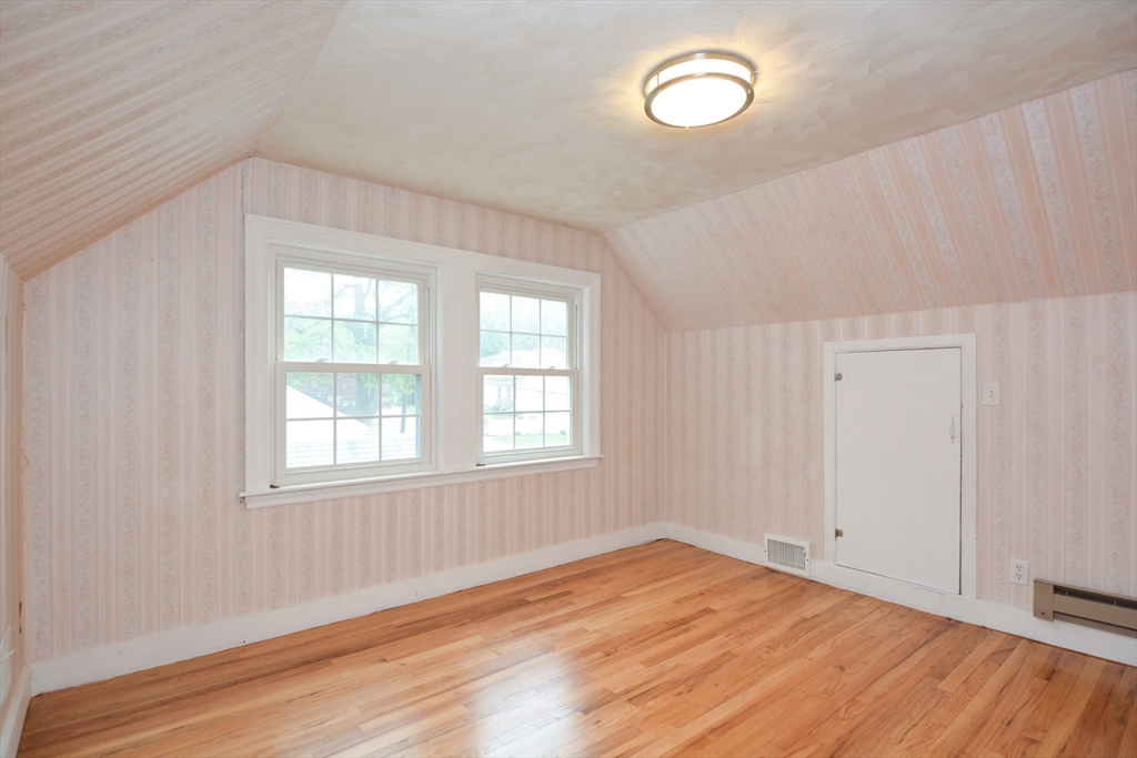 95 Sunset Avenue Dedham, MA 02026 - Photo 7 of 39 an empty room with wooden floor and windows