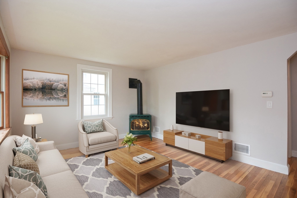 95 Sunset Avenue Dedham, MA 02026 - Photo 10 of 39 a living room with furniture and a flat screen tv