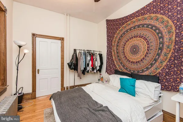 a bedroom with a bed and a mirror