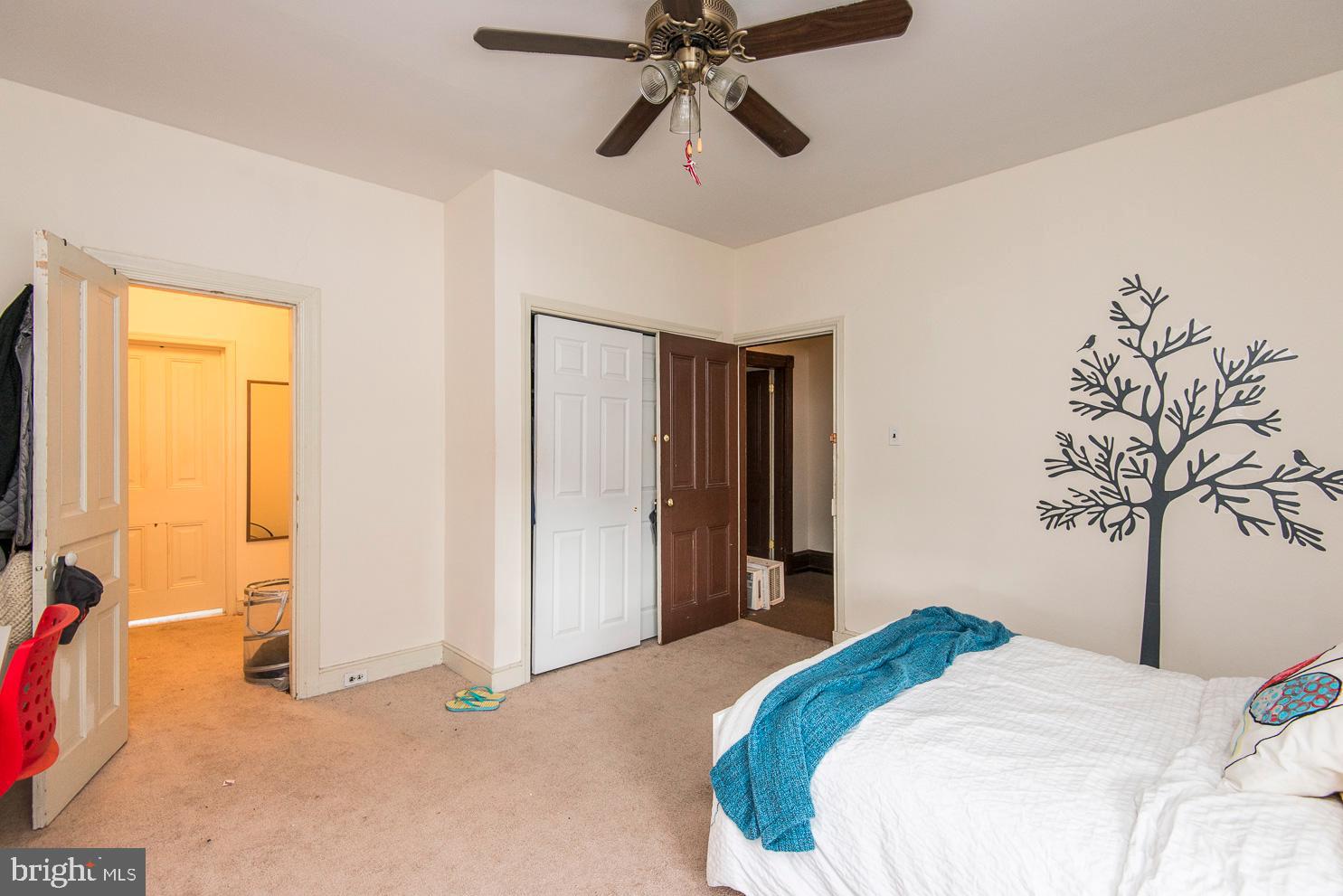 133 Dupont Street Philadelphia, PA 19127 - Photo 16 of 24 a bedroom with a bed and a chandelier