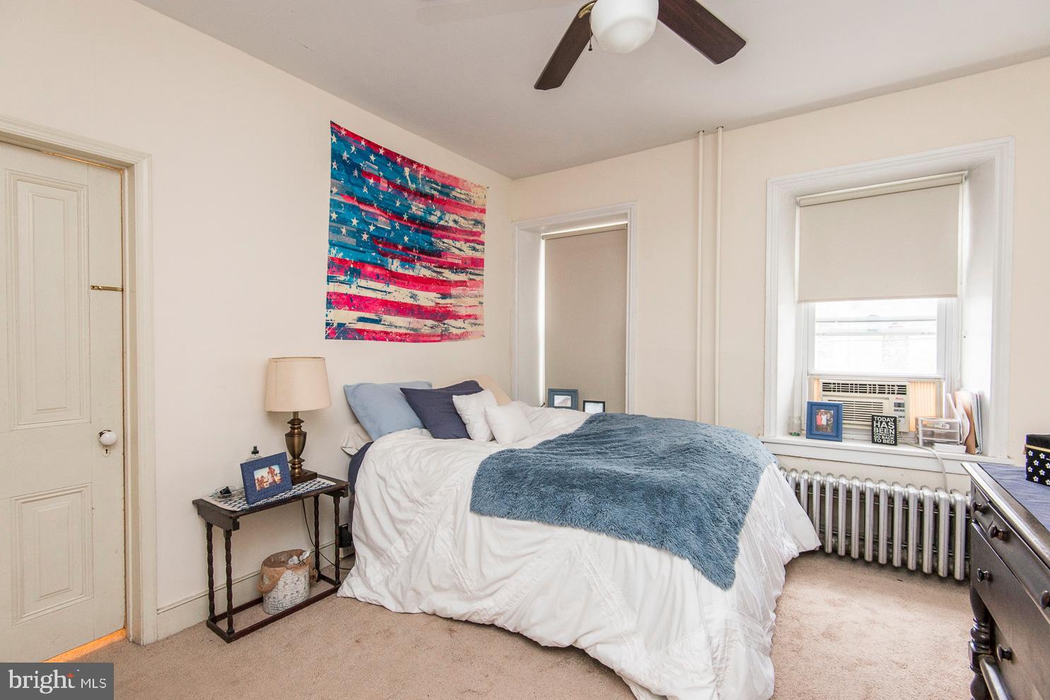 133 Dupont Street Philadelphia, PA 19127 - Photo 17 of 24 a bedroom with a bed and a chandelier