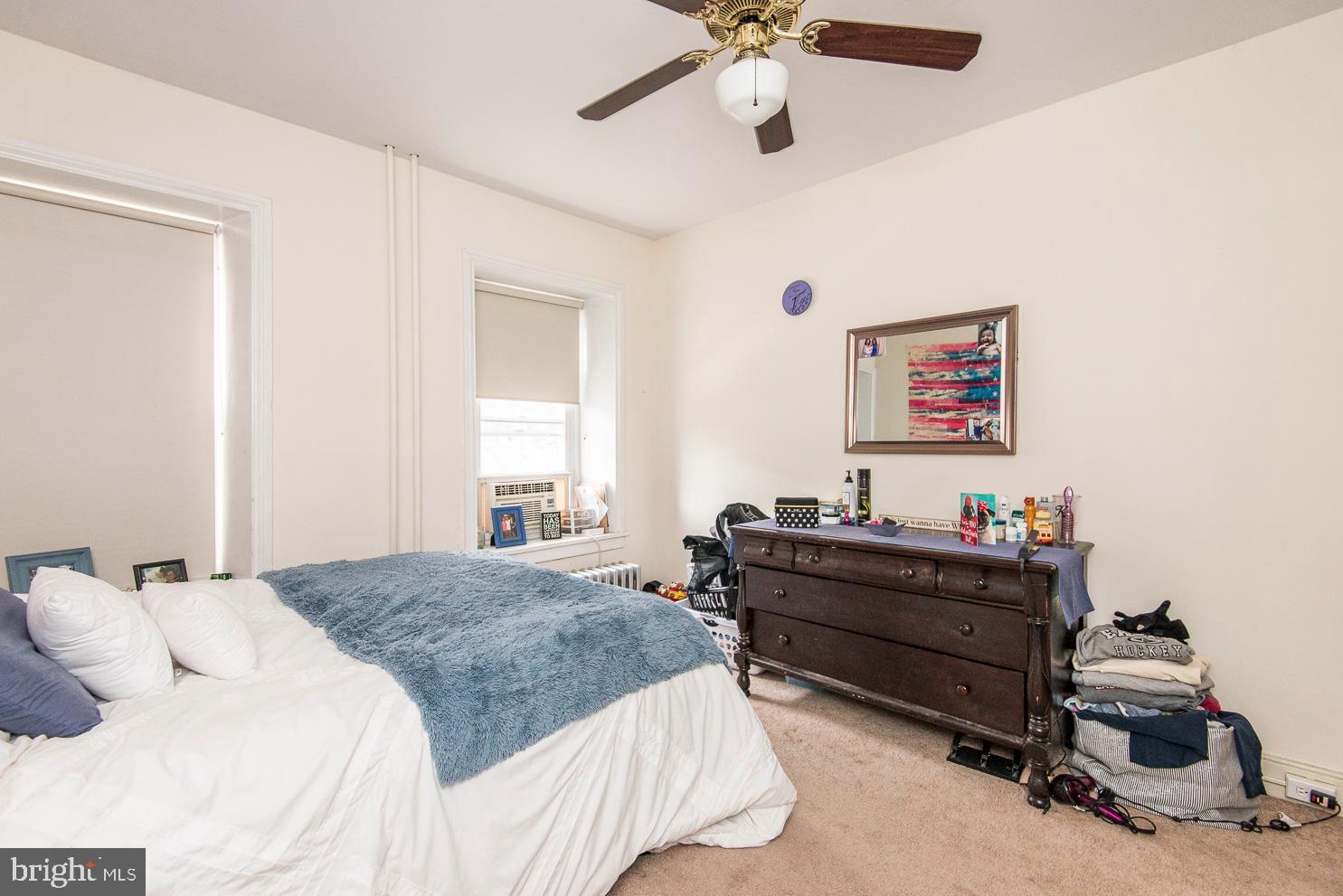 133 Dupont Street Philadelphia, PA 19127 - Photo 18 of 24 a bedroom with a bed and a chandelier