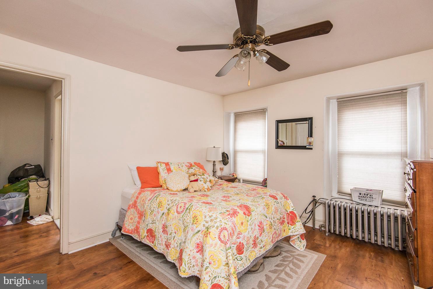 133 Dupont Street Philadelphia, PA 19127 - Photo 22 of 24 a bed room with a bed and a chandelier