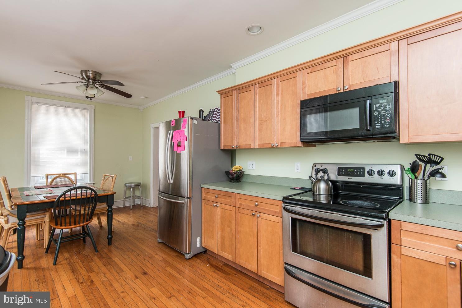133 Dupont Street Philadelphia, PA 19127 - Photo 4 of 24 a kitchen with stainless steel appliances granite countertop a stove microwave and sink
