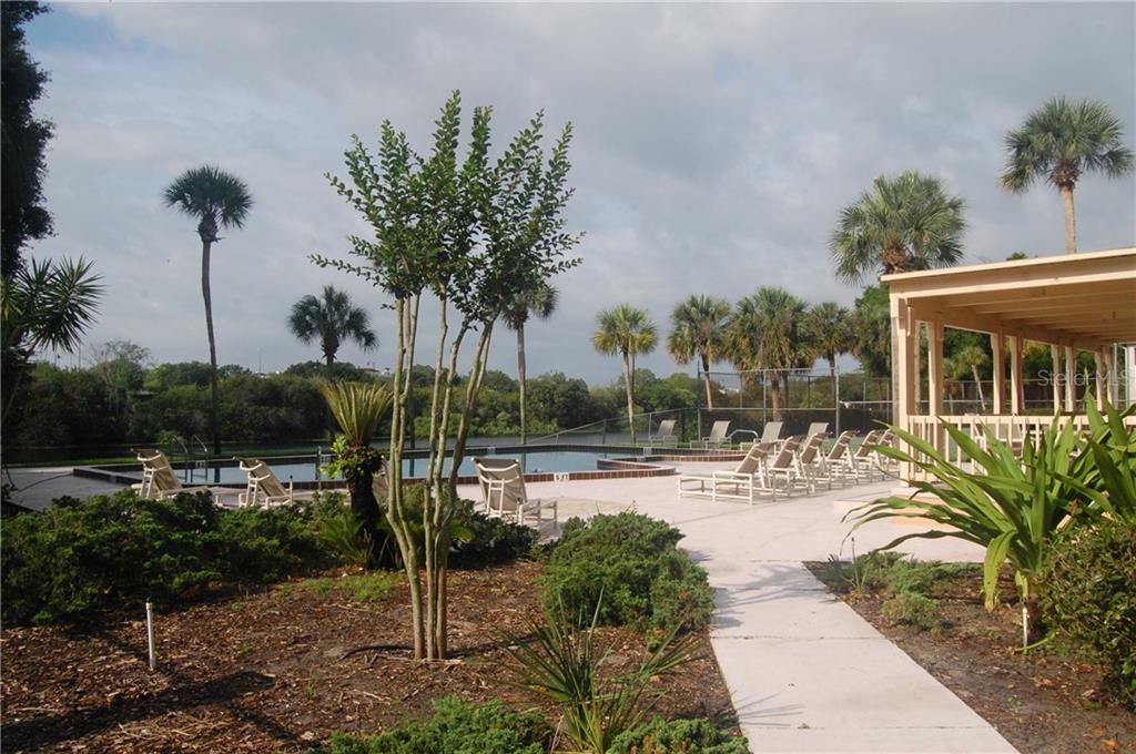 610 Cranes Way, Unit 302 Altamonte Springs, FL 32701 - Photo 1 of 1 a view of a swimming pool with a patio and a garden