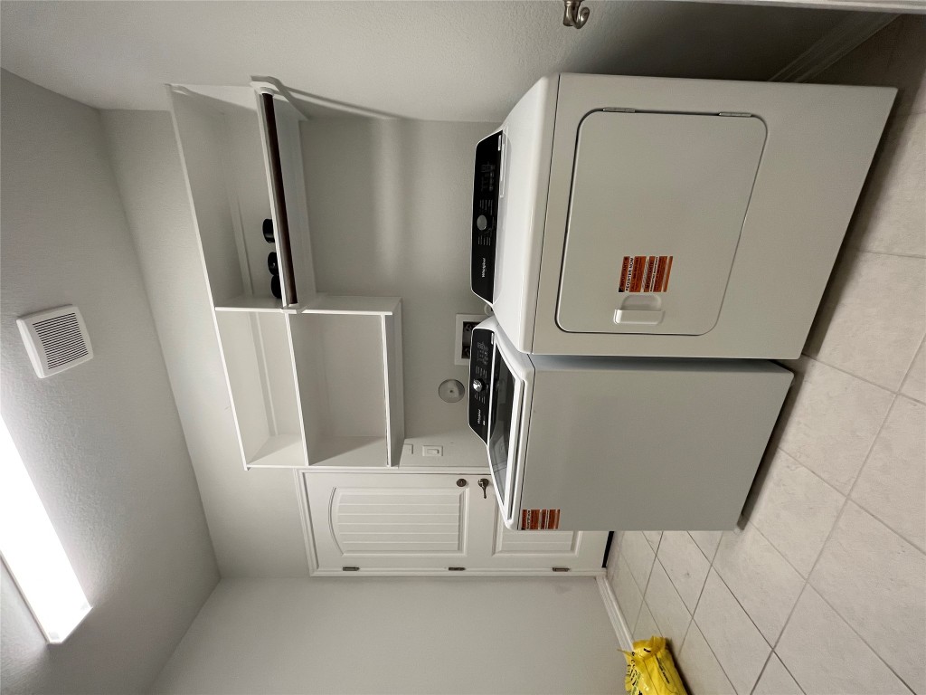 121 Red Granite Road Georgetown, TX 78633 - Photo 17 of 23 Laundry area with light tile patterned floors and washer and dryer