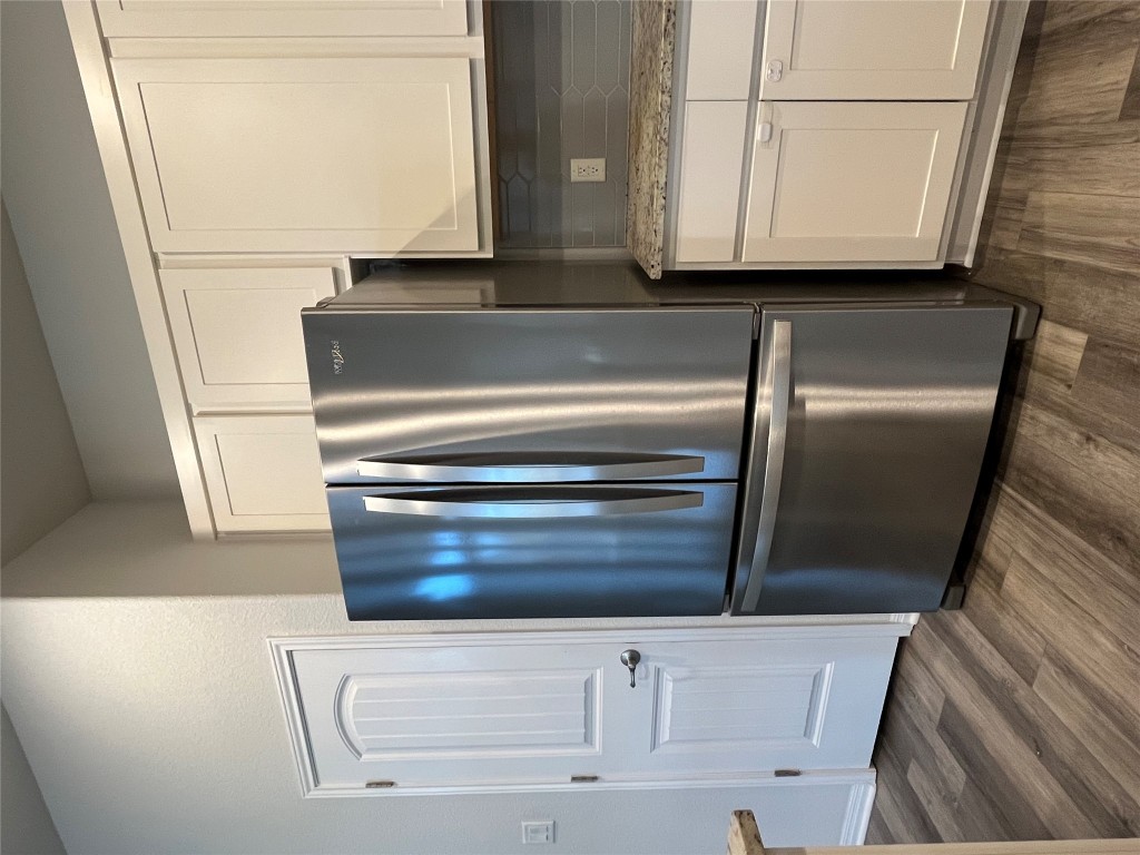 121 Red Granite Road Georgetown, TX 78633 - Photo 19 of 26 a metallic refrigerator freezer sitting in a kitchen