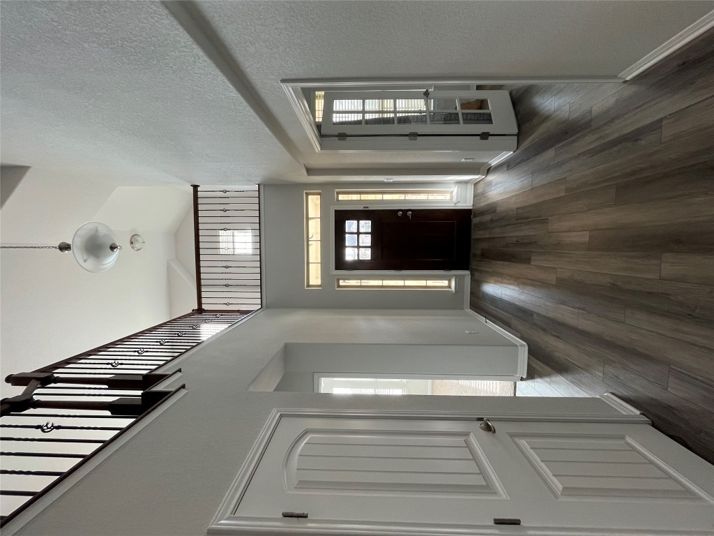 121 Red Granite Road Georgetown, TX 78633 - Photo 21 of 23 Foyer with dark wood finished floors, high vaulted ceiling, and a textured wall