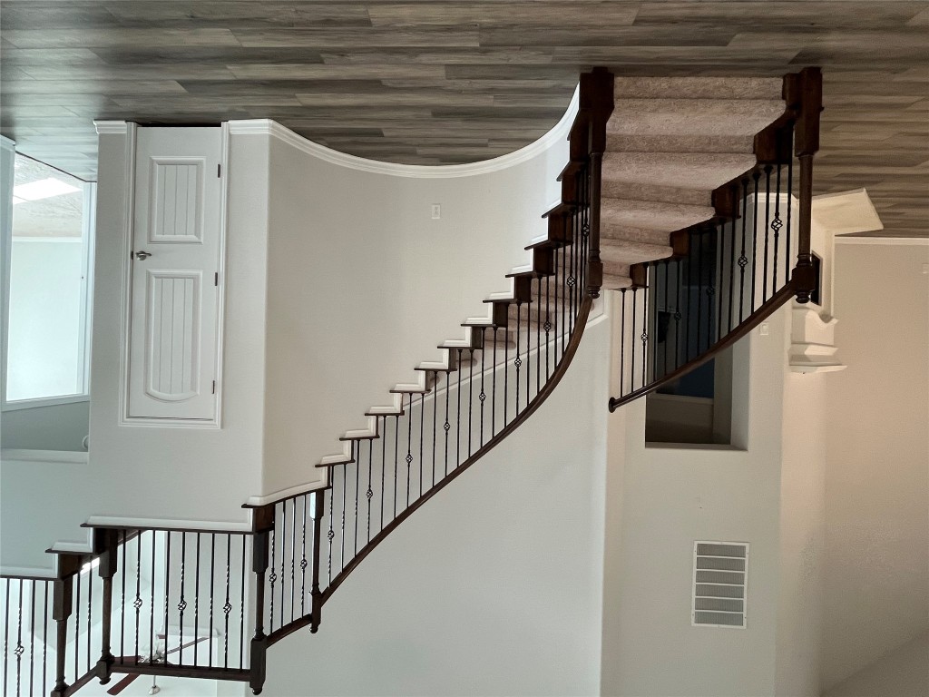 121 Red Granite Road Georgetown, TX 78633 - Photo 4 of 23 Stairway featuring a towering ceiling and wood finished floors