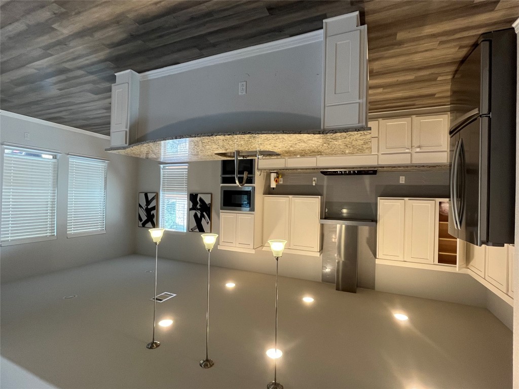 121 Red Granite Road Georgetown, TX 78633 - Photo 7 of 26 a large kitchen with stainless steel appliances lots of counter space and a sink