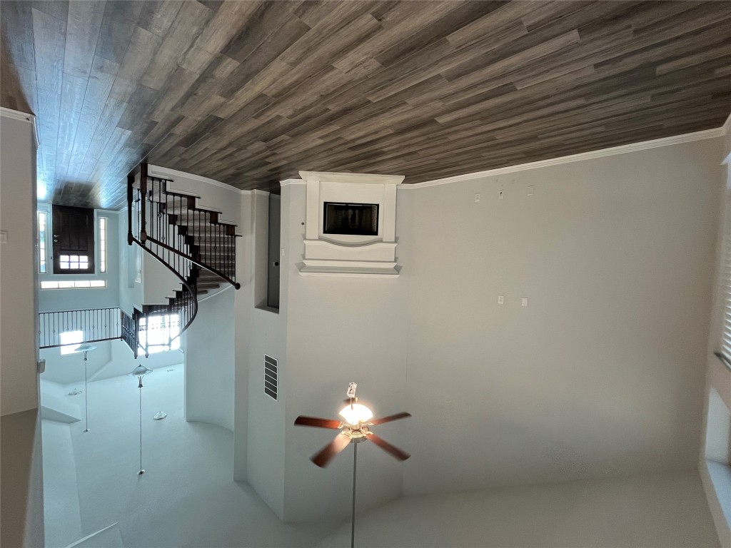 121 Red Granite Road Georgetown, TX 78633 - Photo 9 of 23 Unfurnished living room with a fireplace with raised hearth, high vaulted ceiling, stairway, dark wood-style flooring, and ceiling fan