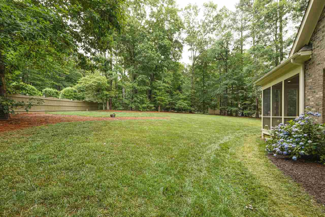 1408 Caistor Lane Raleigh, NC 27614 - Photo 13 of 18 Lush landscaping with plenty of space for enjoying the outdoors! 3 car garage with CHARGER and 8 Zone IRRIGATION! Yard