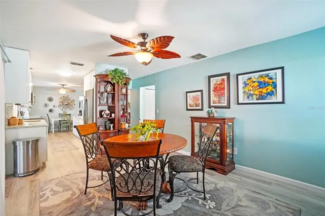 a view of a dining room with furniture and a chandelier