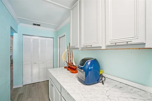 a kitchen with granite countertop a sink and a stove with wooden floor