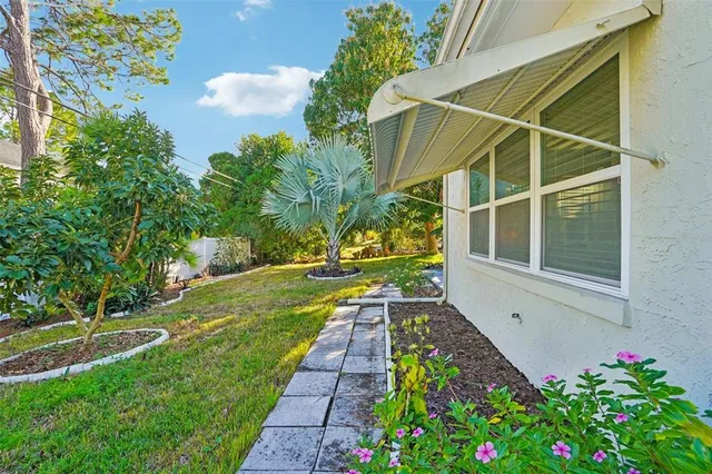 a view of a house with a yard and garden