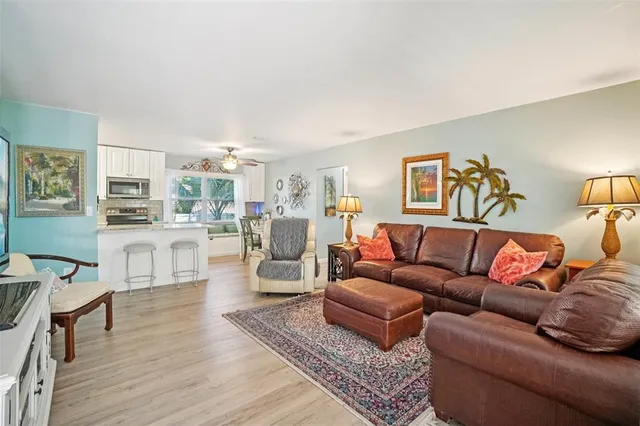 a living room with furniture and view of kitchen