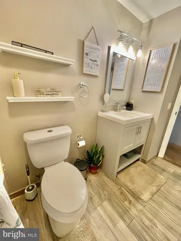 a bathroom with a toilet sink and mirror